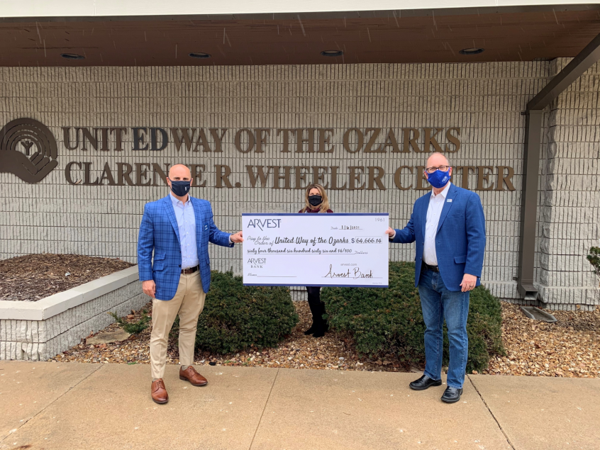image of Kyle Hubbard, President of Arvest Bank-Springfield, and Pam Yancey, a UWO Board member and Community Market Director, EVP of Arvest Bank, and Greg Burris, President and CEO of United Way of the Ozarks, holding a check in front of the United Way building